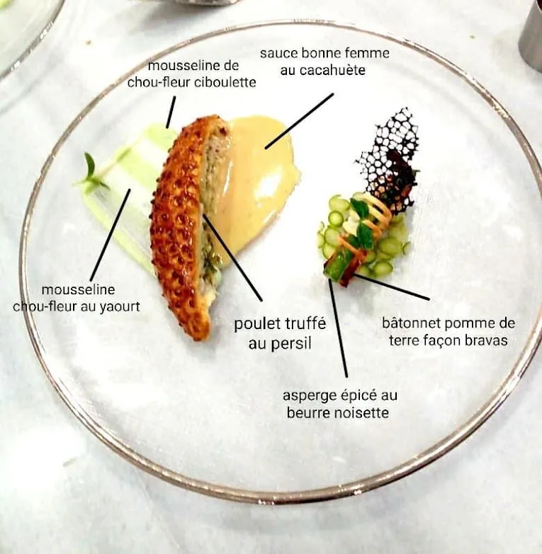 Chef searing ingredients in a hot pan over open flame