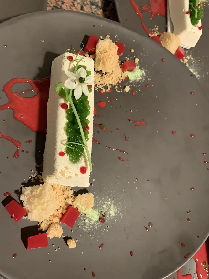 Mexican-inspired signature dessert by Chef Franko with cream, berries and herbs
